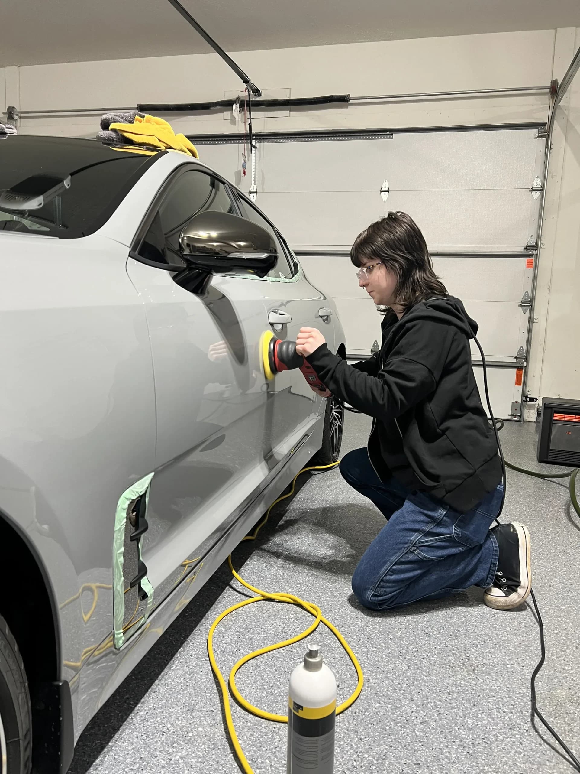 Maryam polishing a car