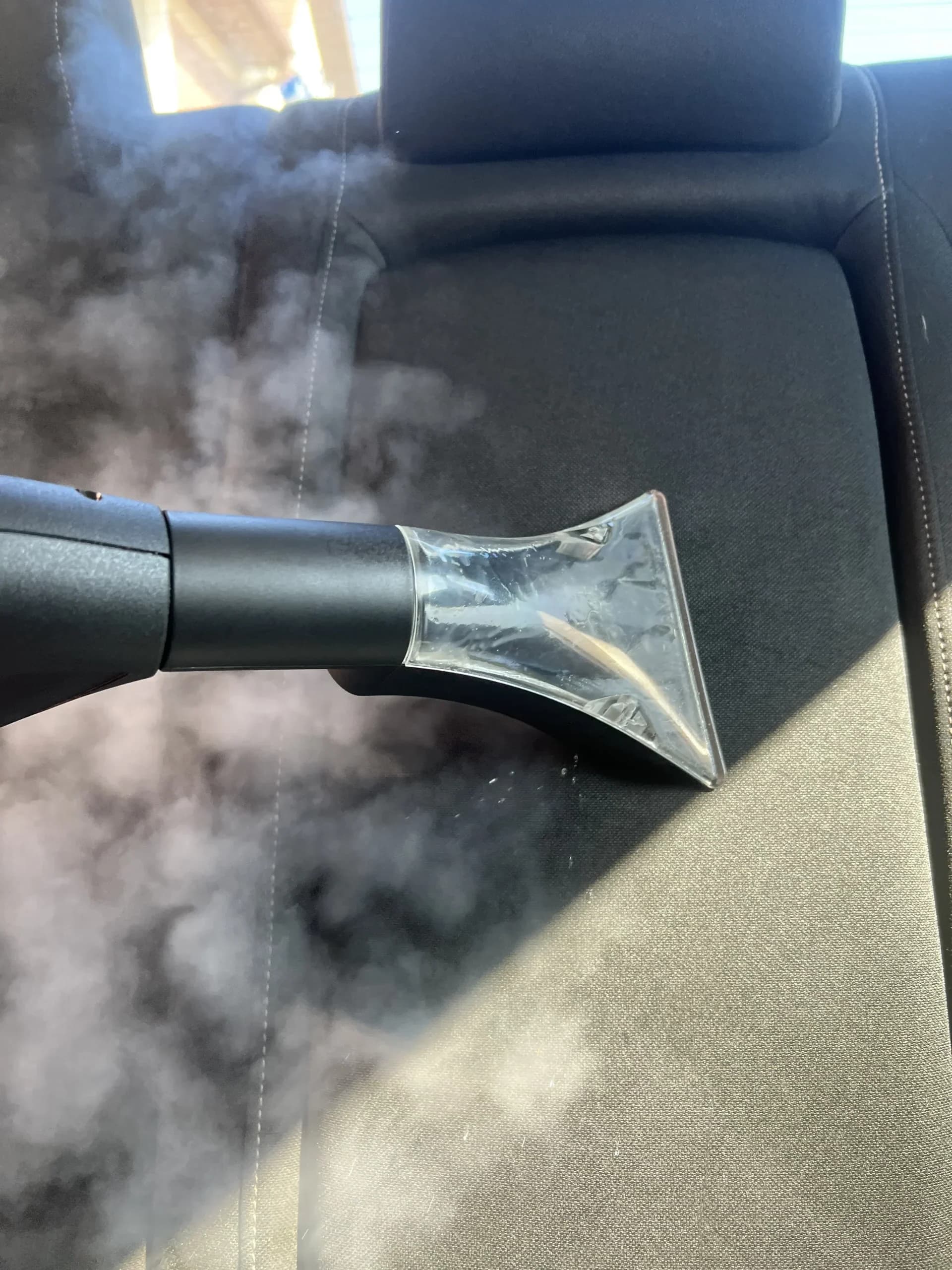 Steam cleaning a car seat